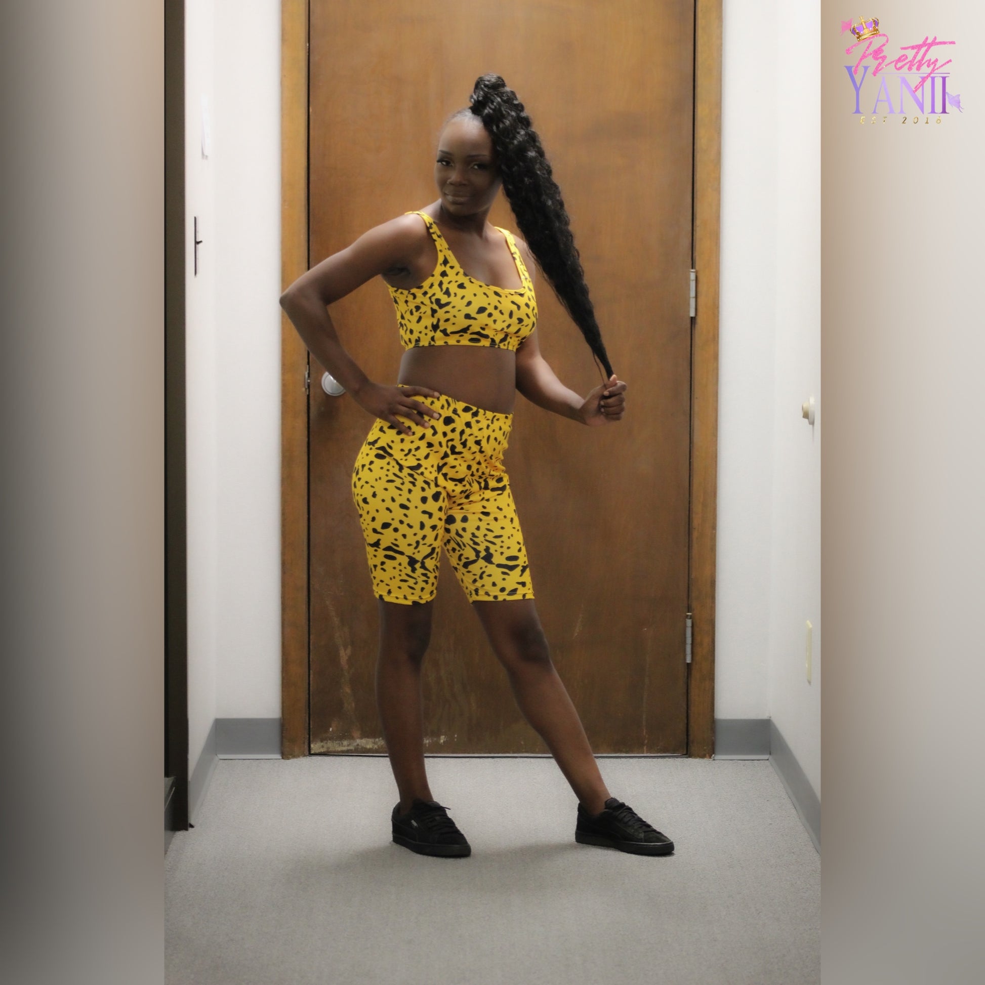 yellow and black leopard matching set consisting of a crop tank top and biker shorts