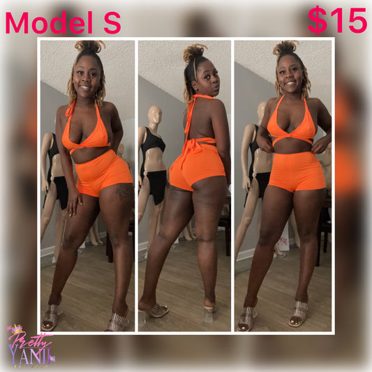 Matching set vibrant orange halter top with high-waisted shorts and an open back