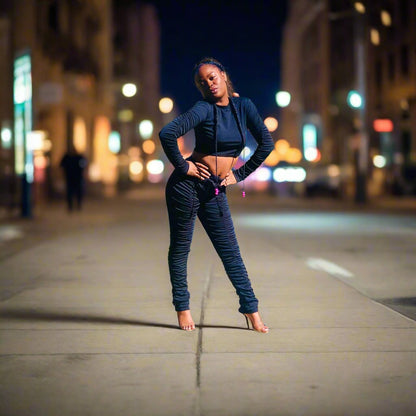 long-sleeve crop top in black stretch nylon material, paired with stacked pants